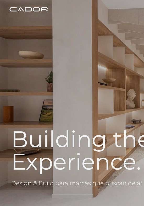 Portada de la web de Cador: el titular «Building the Experience» sobre un interior con escalera y estanterías de madera.